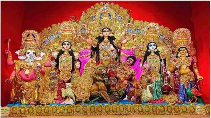 Traditional Durga Puja idol set with ornate decorations and vibrant colors.