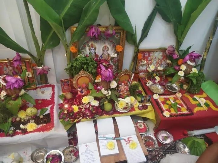 Traditional Hindu altar with deities, flower arrangements, and religious offerings.